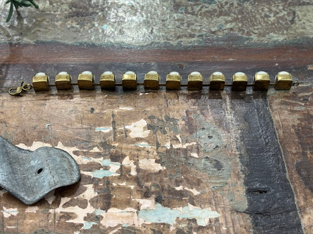 Faux pearls in antique brass